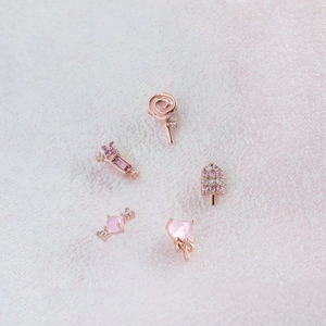 Macro detail of pink ice cream and candy stud earrings set with sparkling zircons