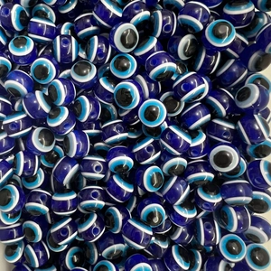 Detailed view of bulk blue evil eye resin beads for DIY jewelry making and necklaces