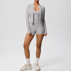 Three-piece light grey yoga set with zip jacket, sports bra, and high-waist shorts