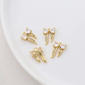 Close-up of 14K gold plated bow heart pendant with zircons showing 9x14mm dimensions