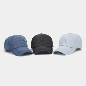 Close-up showing three denim baseball caps in dark blue, charcoal, and light blue wash