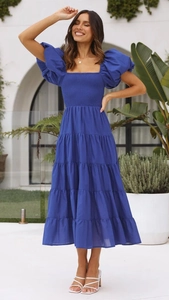Detailed view of the royal blue smocked bodice and puff sleeves of the midi dress