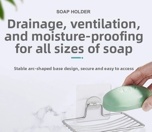 Close-up of stainless steel soap holder with curved bottom and adhesive wall mount