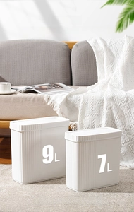 Sleek white narrow trash can with 9L and 7L size options in a modern living room setting