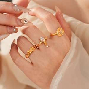 Detailed view of vintage gold ring set with zirconia floral and teardrop patterns