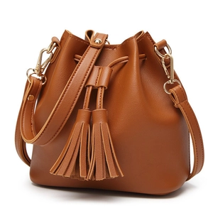 Brown PU leather bucket bag with fringe tassels and gold-tone hardware on white background