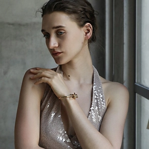 Minimalist 18K gold plated stainless steel bow knot bracelet worn by a model