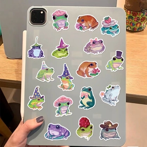 Cartoon frog stickers shown applied on a gray tablet back for DIY decoration