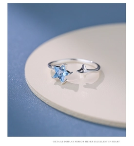 Detail view of the S925 silver star ring featuring light blue zircon and open band design