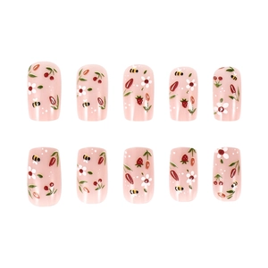 Glossy pink press-on nails set with floral, strawberry, and bee patterns on white background