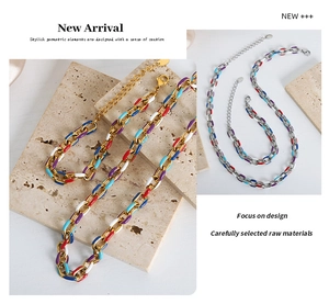 Detailed macro of a colorful enamel link necklace with gold and silver finishes