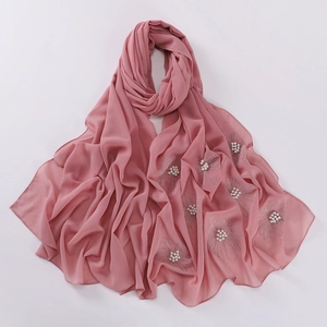 Detail of pink chiffon scarf featuring elegant pearl and rhinestone flower patterns