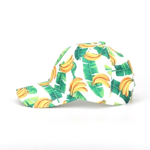 Close-up of tropical tie-dye baseball cap featuring yellow banana and green leaf prints
