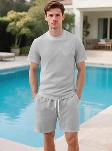 Detail of light gray waffle knit texture on men's summer t-shirt and matching shorts