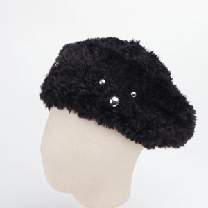Detail of black faux fur beret featuring stylish silver metal studs on plush texture