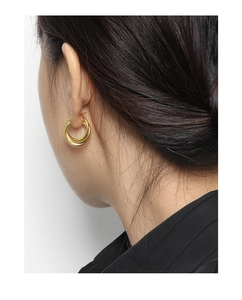 Close-up of a model wearing minimalist layered gold hoop earrings in S925 silver