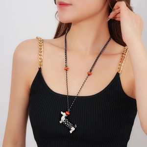 Detail view of woven cotton rope necklace featuring a ceramic dachshund puppy pendant