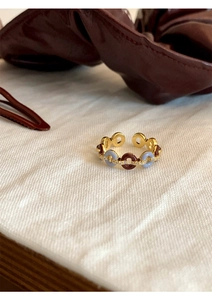 Macro shot of French vintage open ring with brown blue enamel and pavé zircon details