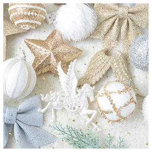 Detailed close-up of champagne gold glitter Christmas ornaments on white plush background