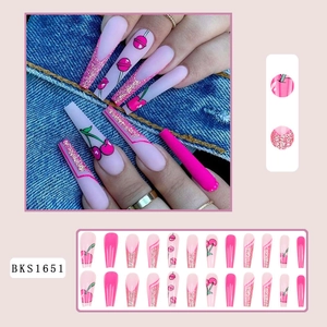 Detail of 24pcs long coffin press-on nails featuring glitter and hand-painted cherries