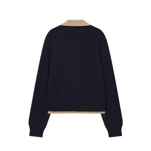 Navy blue knitted polo shirt with contrast beige trim back view on white background