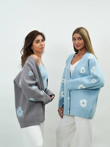 Detail of white daisy floral embroidery on loose gray and blue knit cardigans for women
