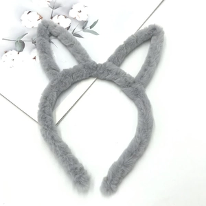 Detail of plush grey cat ear headband with soft faux fur texture on a minimalist background