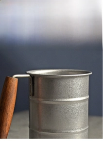 Close-up of rolled rim and wood handle on retro SUS304 stainless steel mug
