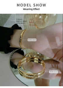 Detail shot of 4mm faceted and 6mm smooth 18k gold plated stainless steel bangles