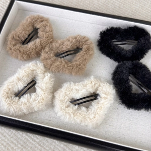 Set of six fuzzy plush heart BB hair clips in khaki, cream, and black for winter