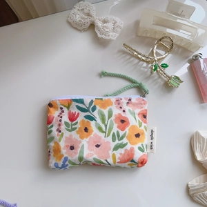 Floral cotton pouch with zipper and green cord handle for lipstick or earphones