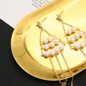 Detailed close-up of natural pearl tassel earrings with gold plating and cubic zirconia