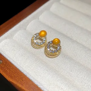 Golden cat eye stone earrings with pavé crystals in geometric double circle design