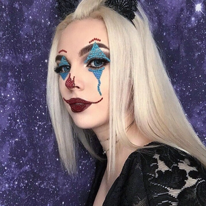 Detail of red and blue 3D crystal face jewels for Halloween joker makeup effect