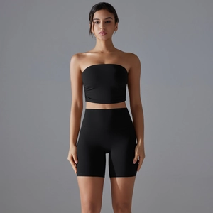 Detail view of black seamless strapless sports top and high-waisted yoga shorts set