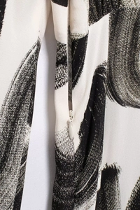 Close-up of the invisible zipper and black ink brushstroke print on this elegant dress