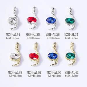 3D snake-shaped nail art charms with crystals in gold and silver metal finishes