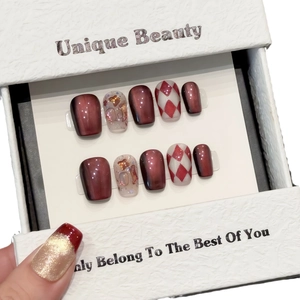 Deep burgundy cat-eye press-on nails with heart sequins and red-white checkered patterns