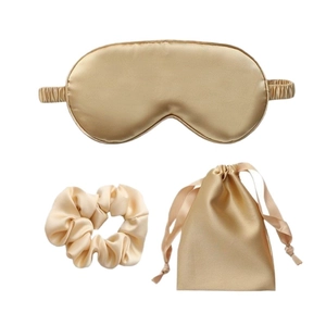 Three-piece golden satin sleep set featuring a padded eye mask, scrunchie, and storage bag