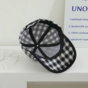 Interior detail of kids plaid baseball cap showing black seam tape and sweatband