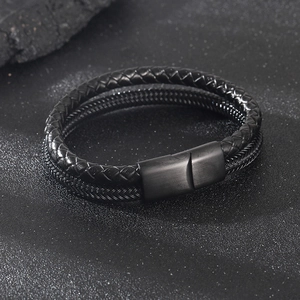 Detail of double-layer black braided leather bracelet with brushed magnetic metal clasp