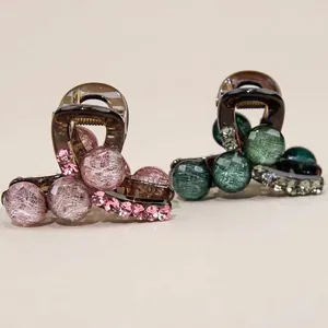 Elegant green and pink beaded hair claws with resin finish and crystal details