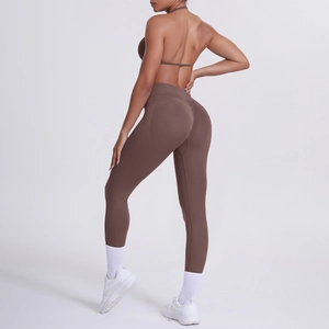Dettaglio dei leggings yoga a vita alta marrone moka e reggiseno sportivo sul modello