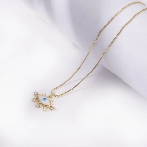 Golden box chain necklace with geometric evil eye pendant and sparkling crystals