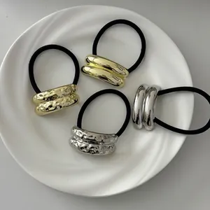 Set of 4 geometric metal hair ties in gold and silver with smooth and hammered textures