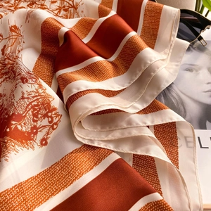 Close-up of orange and white striped silk scarf with vintage Toile de Jouy pattern