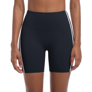 Detail of high-waist black yoga shorts featuring contrast white and pink side stripes