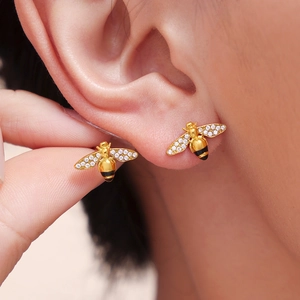 Golden honey bee earrings with zircon wings and black enamel details on earlobe