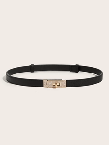 Close-up of black Saffiano leather skinny belt with sparkling gold rhinestone buckle