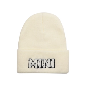 Detailed close-up of MINI letter embroidery on a cream white knitted beanie hat